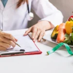 nutritionist giving consultation to patient with healthy fruit and vegetable